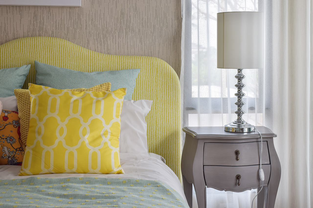 pattern-pillows-on-classic-style-bed-and-reading-lamp